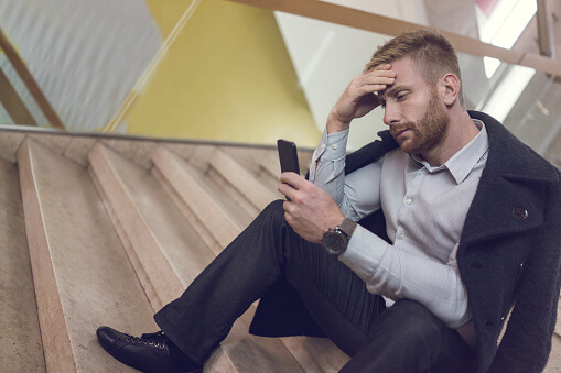 Man Looking Up Alcohol Withdrawal Symptoms on His Phone